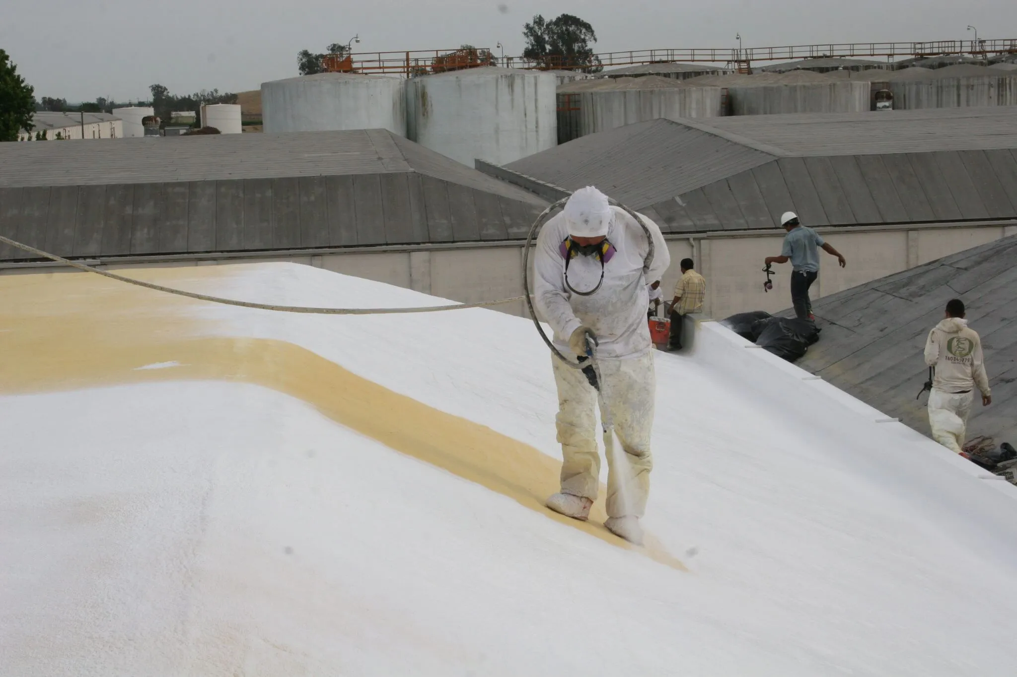 Hulsey Contracting spray foam roofing Hulsey Contracting crew applying spray foam roofing